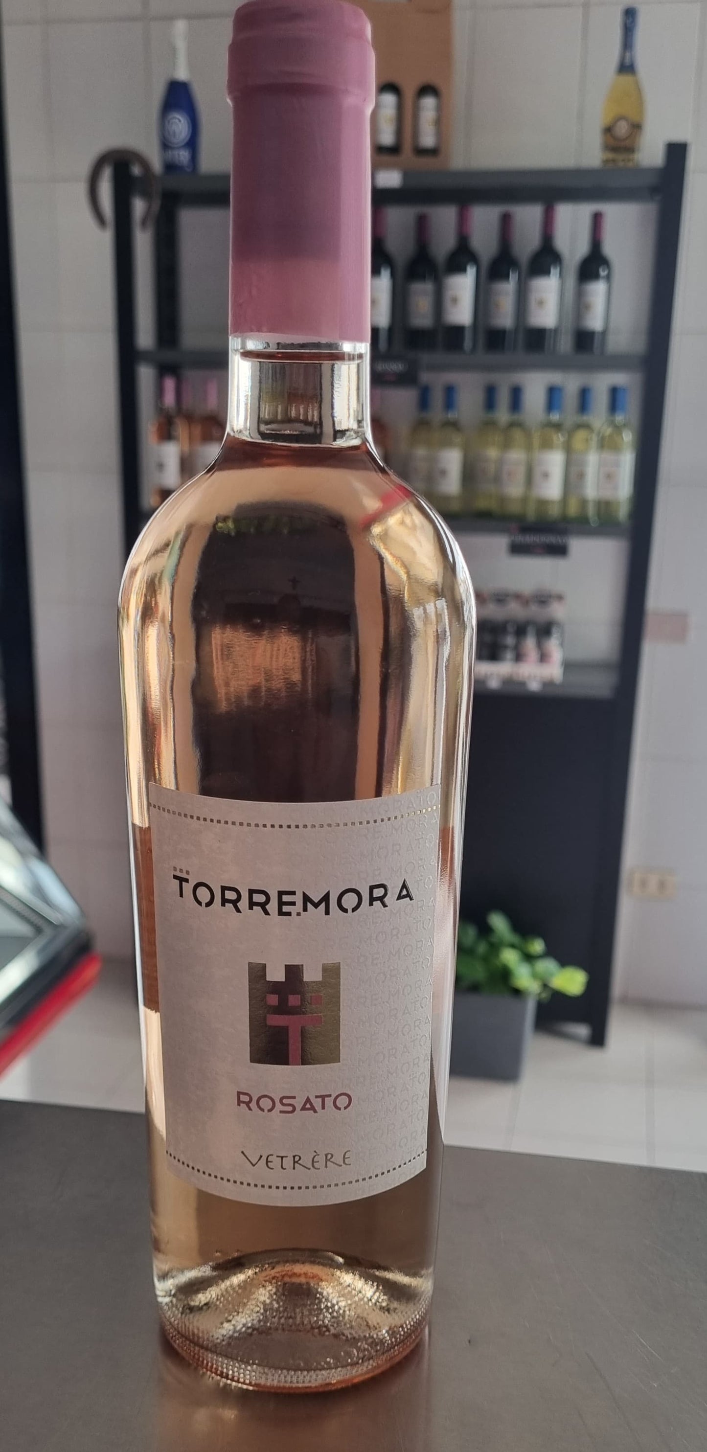 Bottle of Torremora Rosato wine by Vetrère, showcasing pale pink color and elegant design.