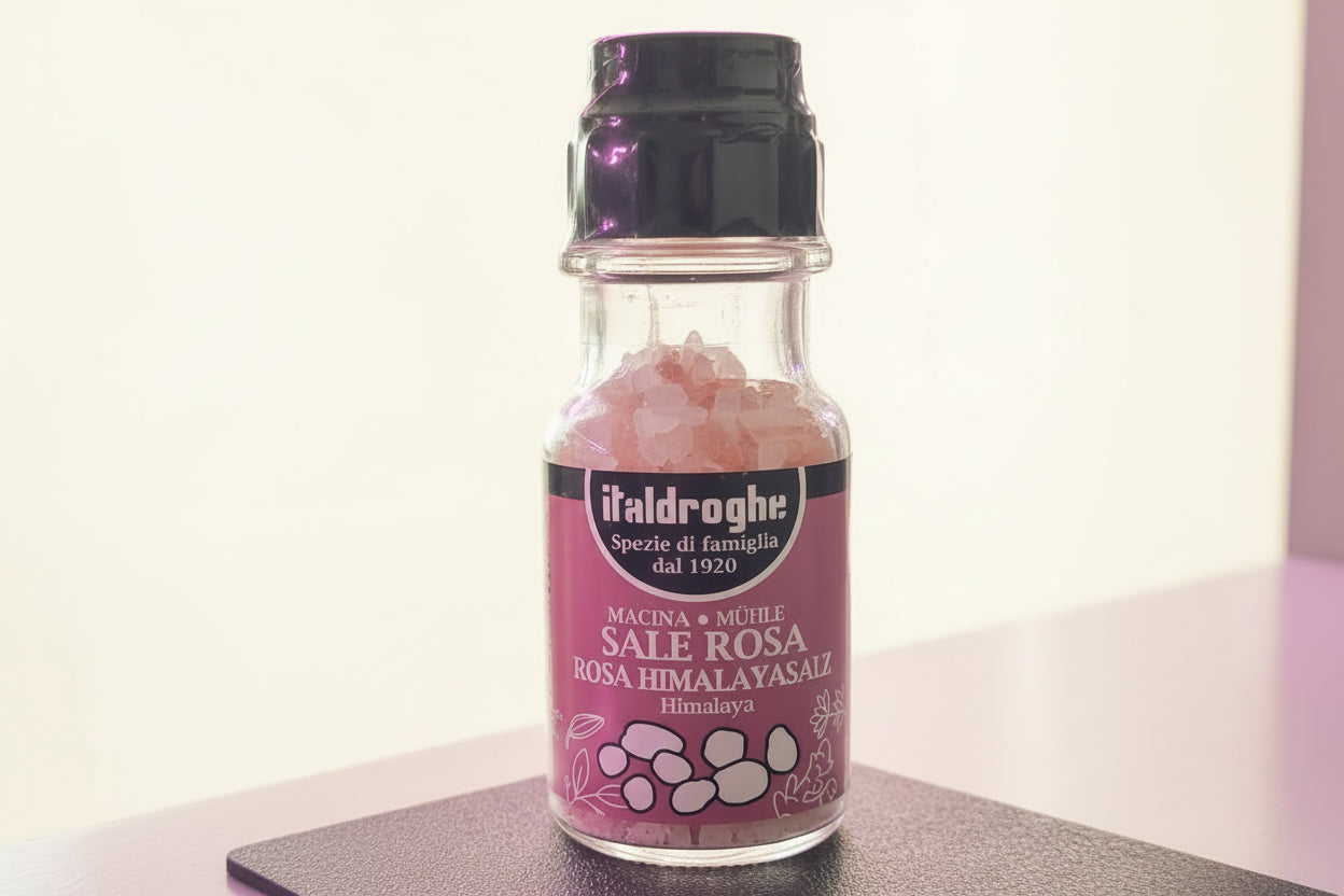 Flacone di sale rosa dell'Himalaya in grani con tappo macinatore incorporato per condimento gourmet.